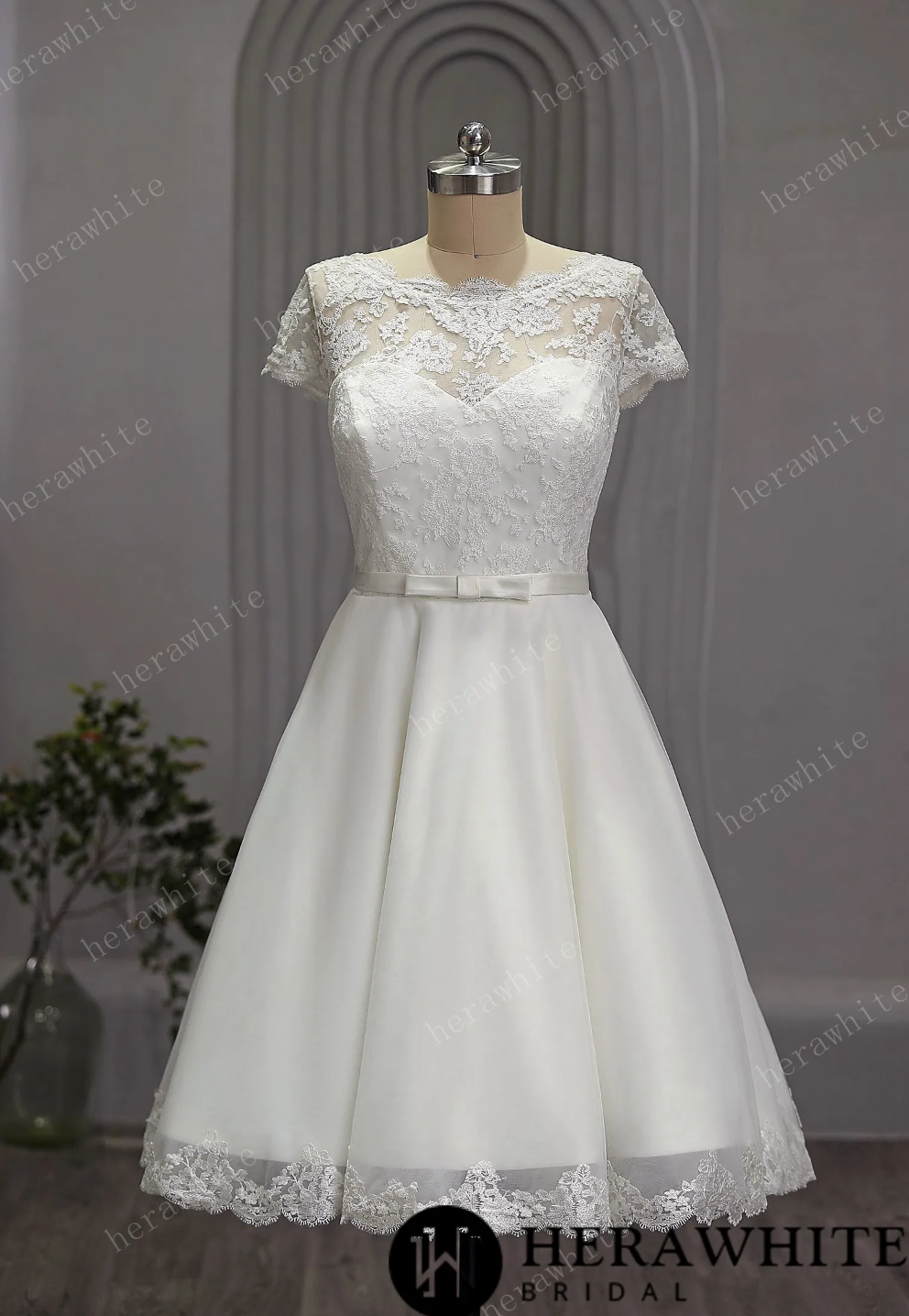 Mini Short Wedding Dress Tulle Lace Cap Sleeves, The length of the dress falls just below the knee, creating a chic and modern silhouette.