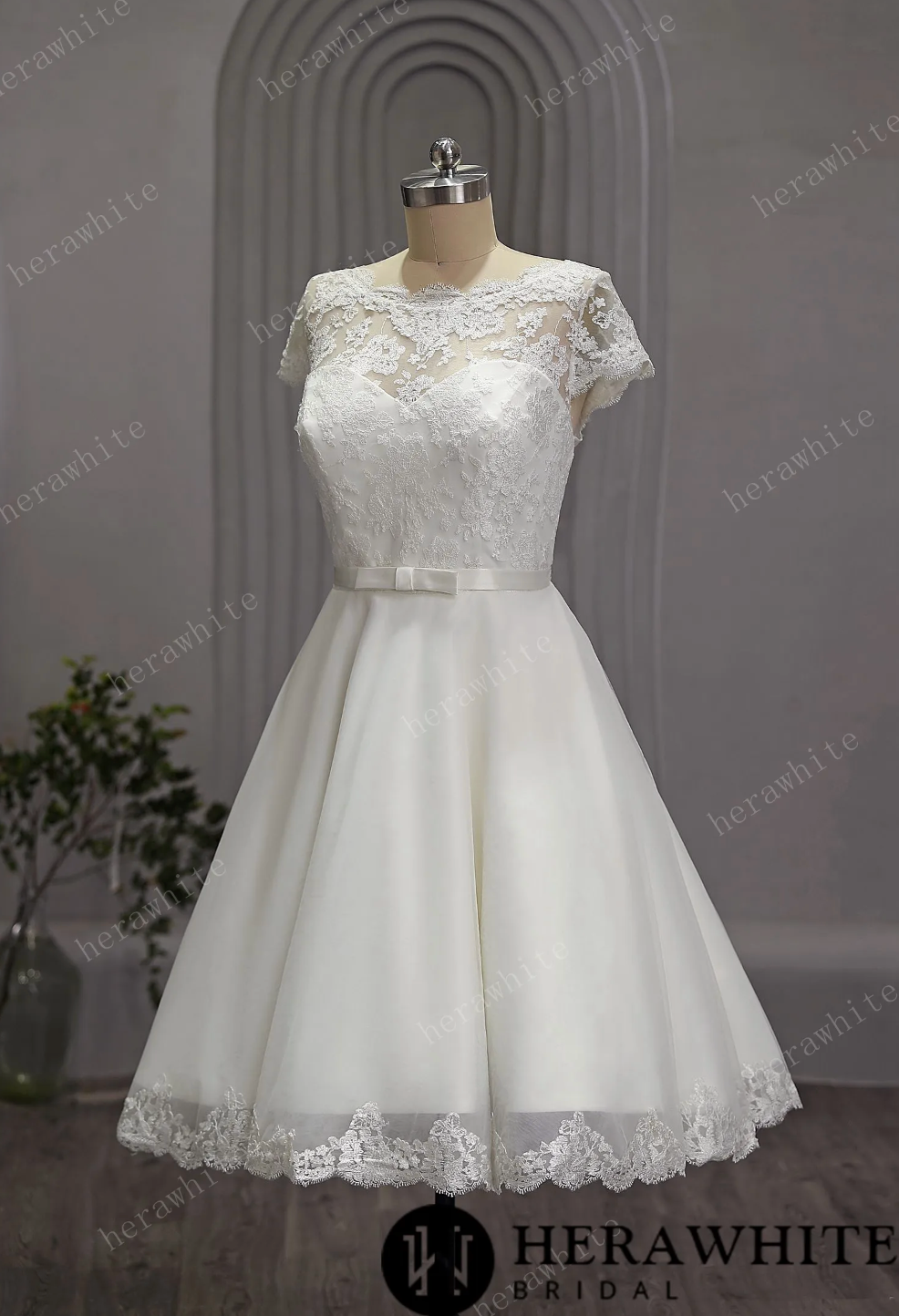 Mini Short Wedding Dress Tulle Lace Cap Sleeves, The length of the dress falls just below the knee, creating a chic and modern silhouette.