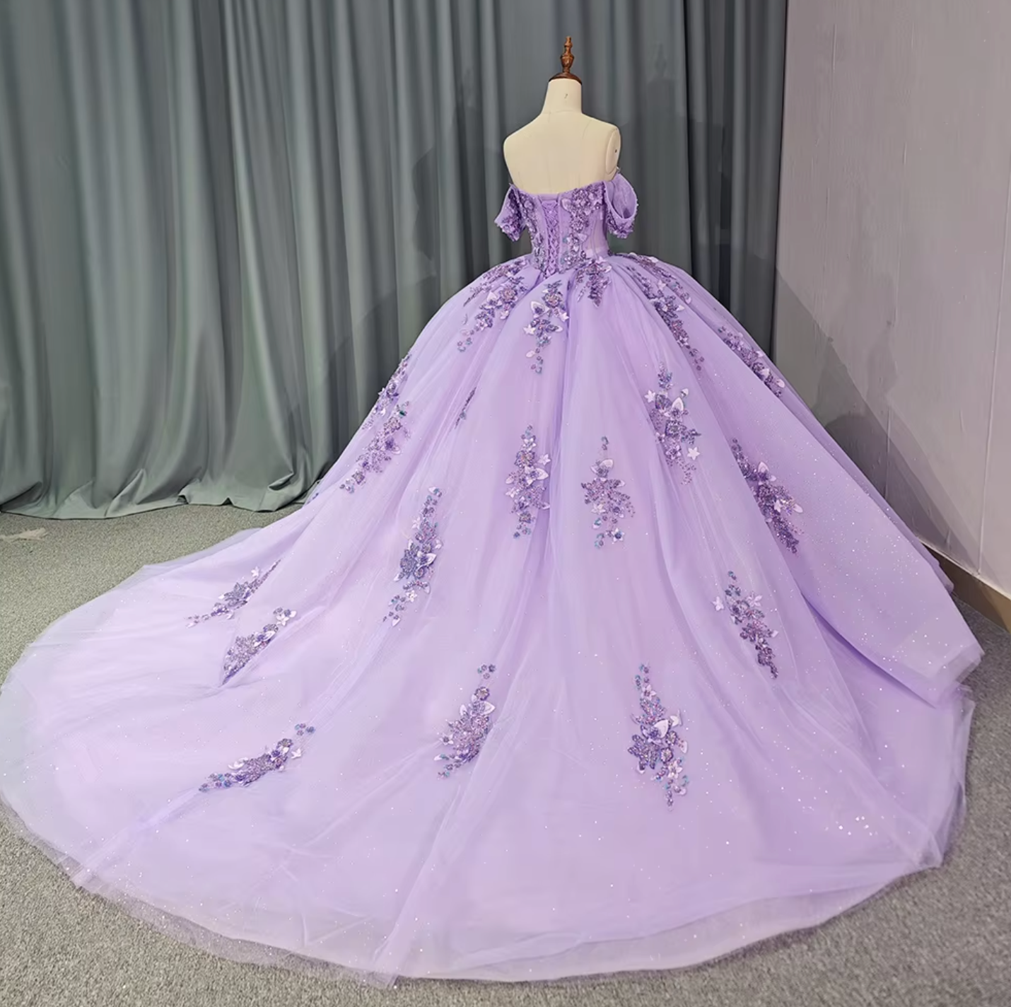 Stunning off the shoulder purple Quinceanera dress with floral accents and full pleated skirt.