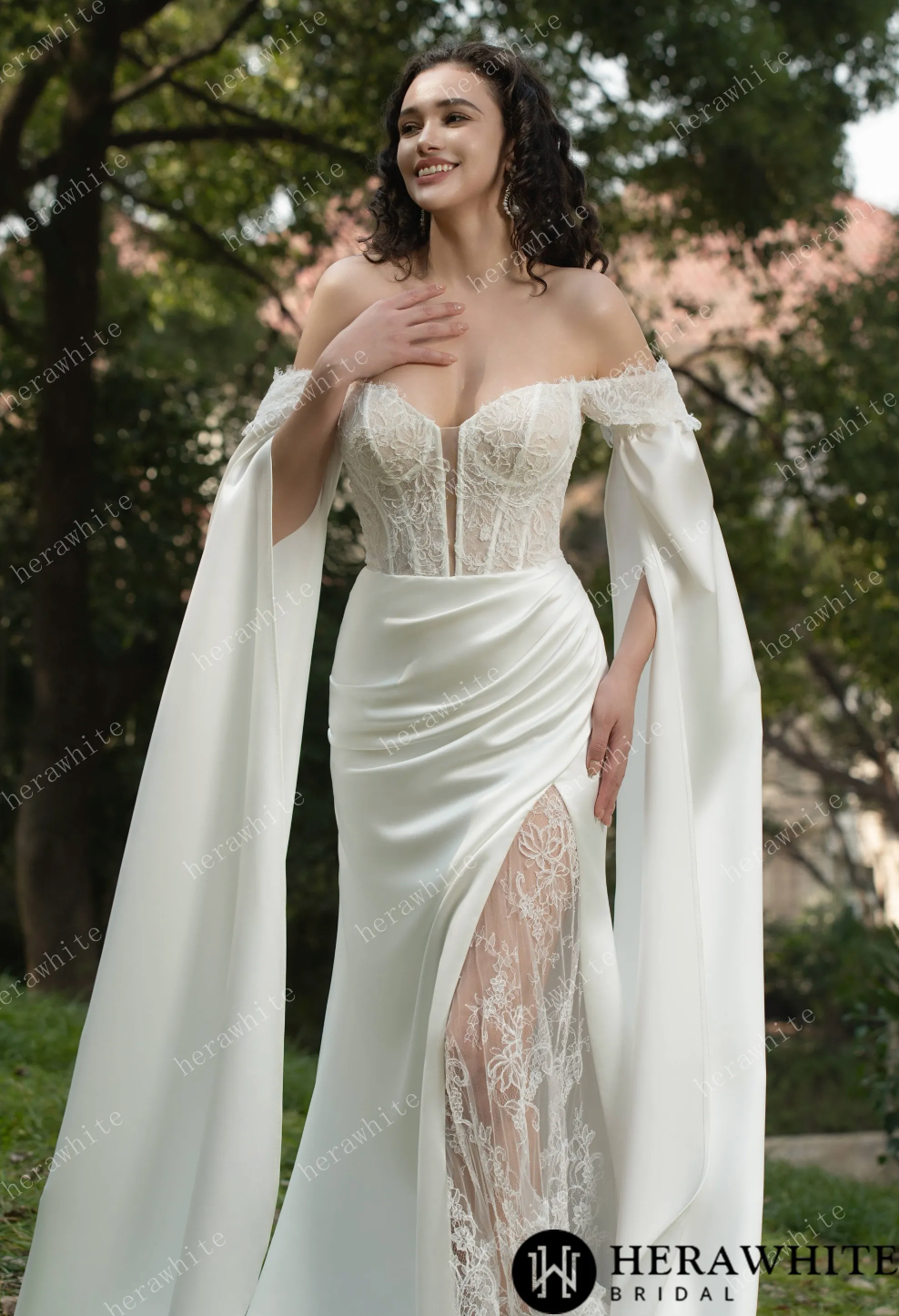 Elegant off-the-shoulder lace wedding dress with a sweetheart neckline and flowing skirt detail.