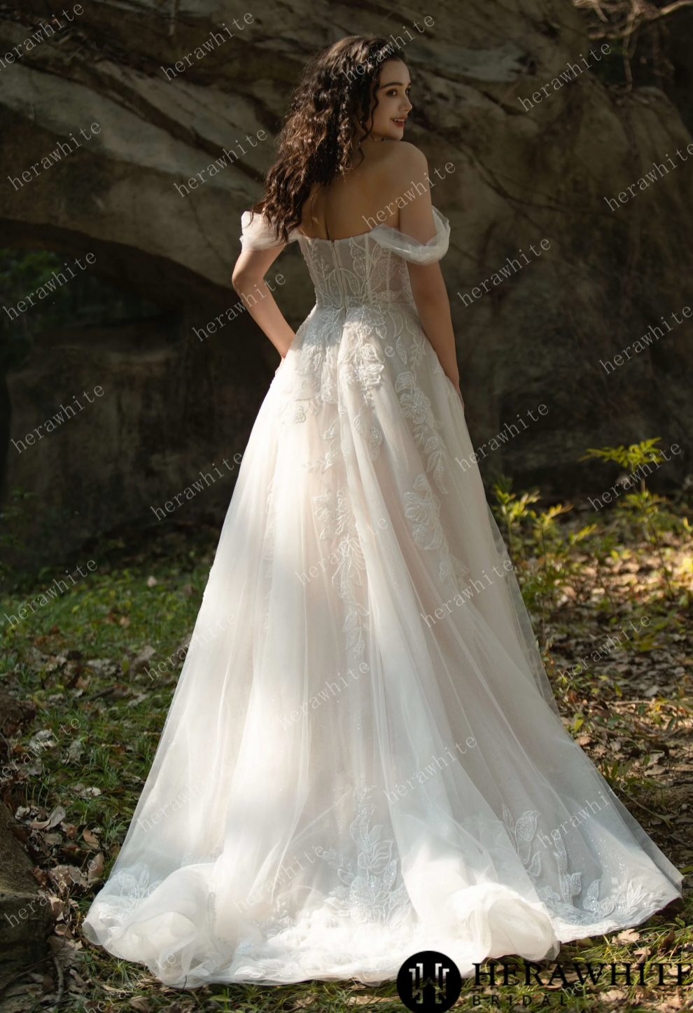 Off the shoulder corset wedding dress with elegant tulle skirt and floral appliqués, showcasing a romantic back view.