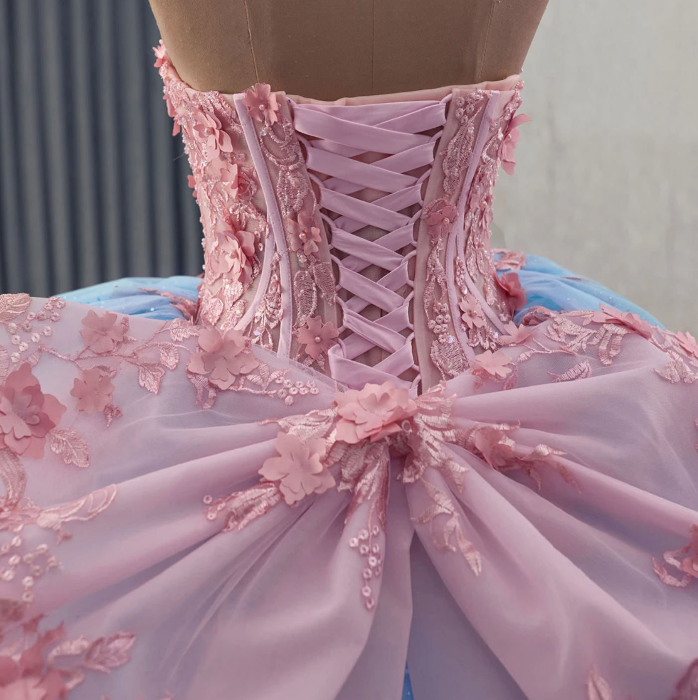 Quinceanera Dress Blue Pink Organza Lace Up Back Ball Gown, combines fantasy and elegance with a sweetheart corset bodice adorned by hand-sewn floral beading.