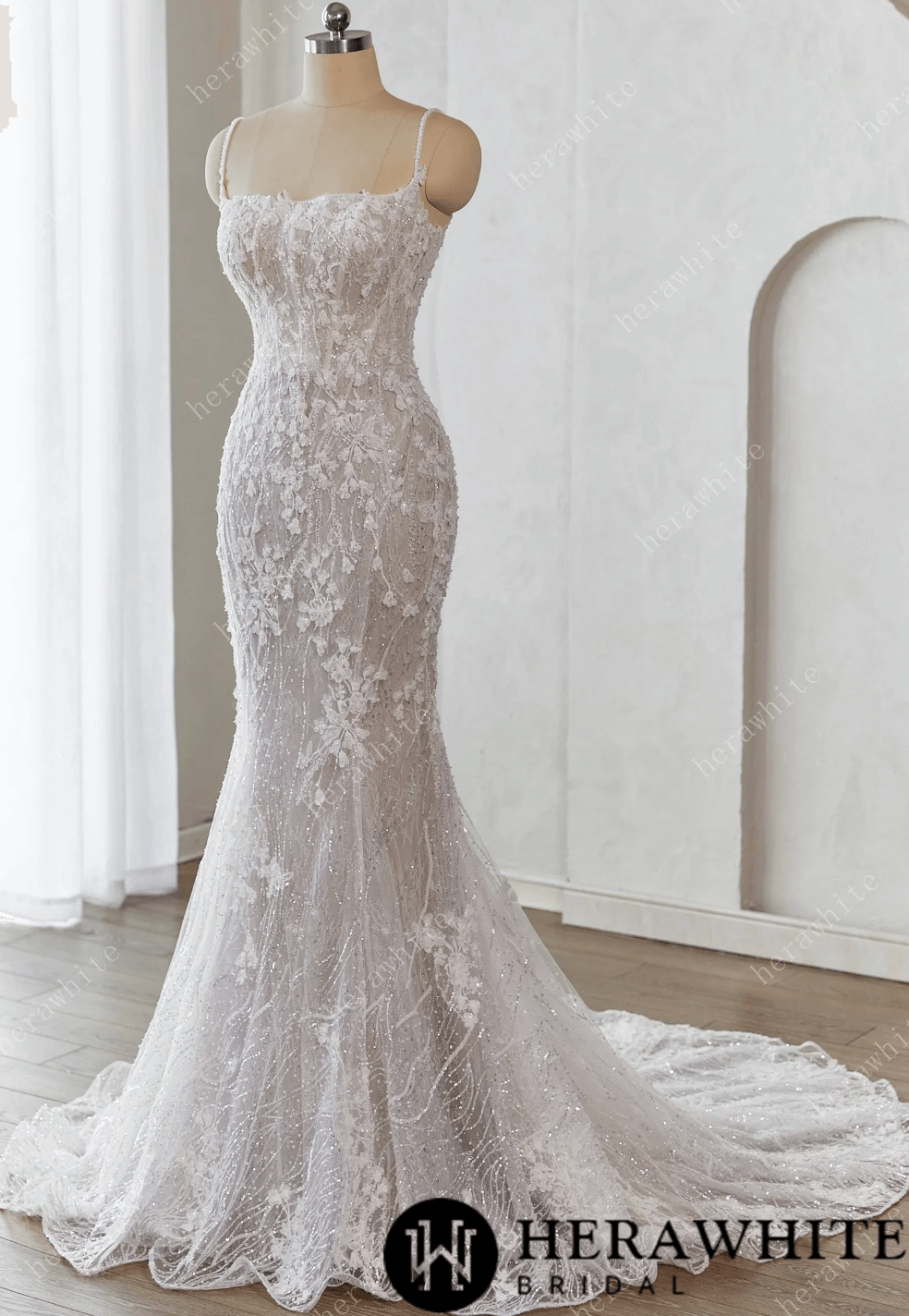 White lace wedding dress on a mannequin against a whiteWedding Dress Lace Tulle Beading Sequins With Train, this sophisticated wedding dress features a fitted bodice embellished with intricate lace background