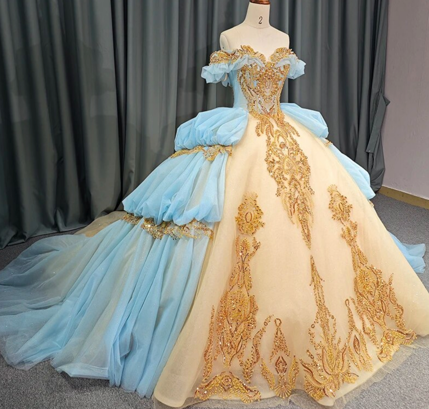 Quinceanera Dress Blue Gold Organza Ball Gown With Train, This unique Quinceanera dress is crafted with luxurious details; a soft, ethereal baby blue hue i