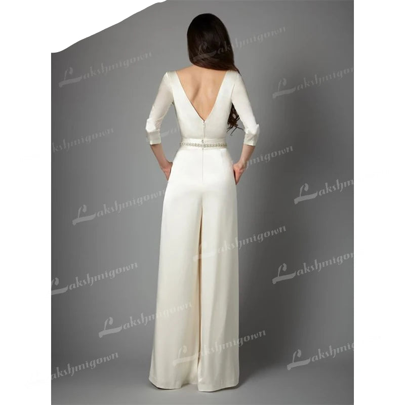 Wedding Jumpsuit Lace Bridal Pants Suit, This sophisticated jumpsuit features a long-sleeve top, wide-leg pants, and a fitted waist sash