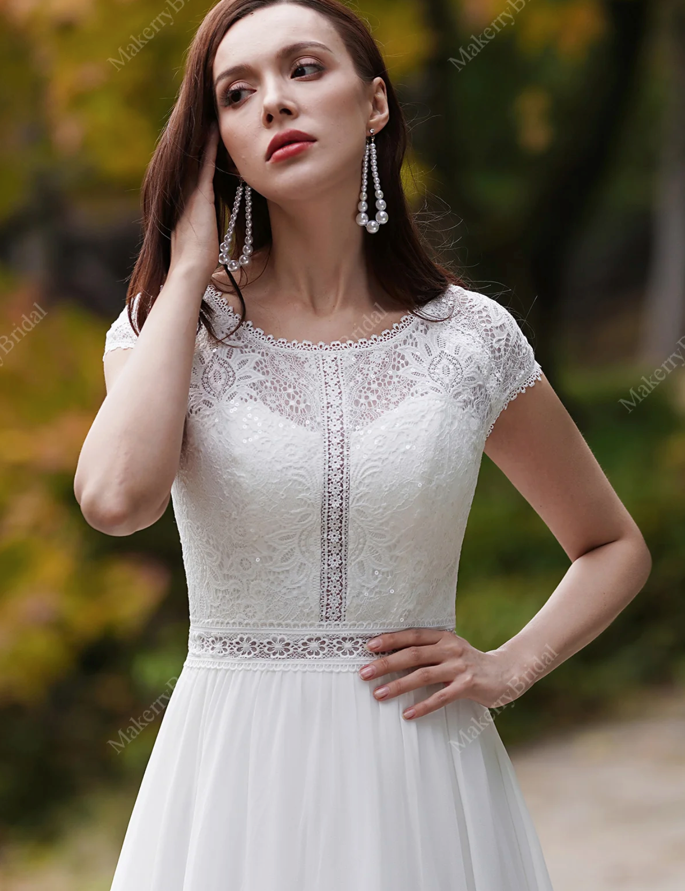 Elegant bride wearing a Chiffon Bohemian Wedding Dress with cap sleeves, showcasing lace details and a bateau neckline.