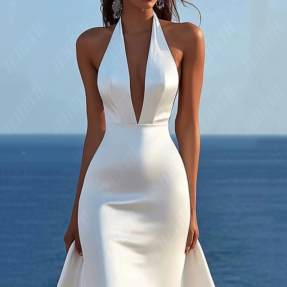 
                      
                        woman in a white mermaid wedding dress with halter top and court train.
                      
                    
