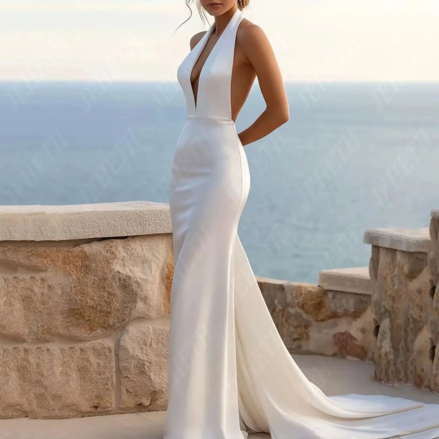 woman in a white mermaid wedding dress with halter top and court train.