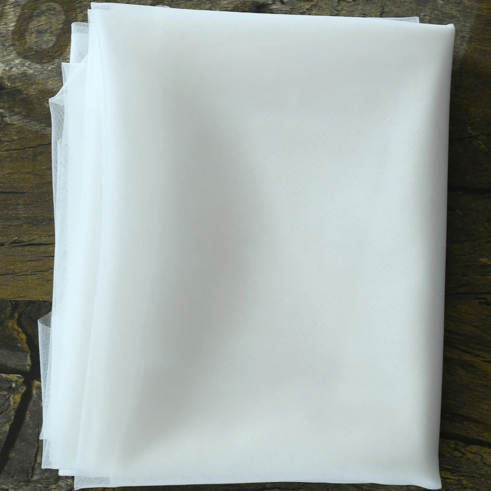 
                      
                        Stack of white paper sheets on a wooden surface
                      
                    