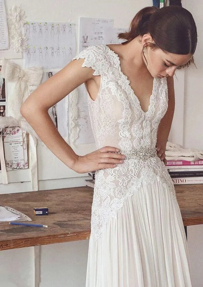 
                      
                        woman in a white boho lace a line wedding dress
                      
                    