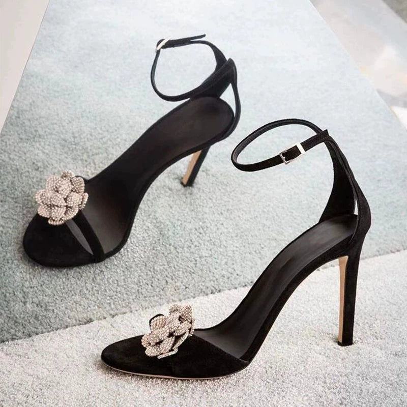 Black high-heeled shoes with floral embellishments crystal flower