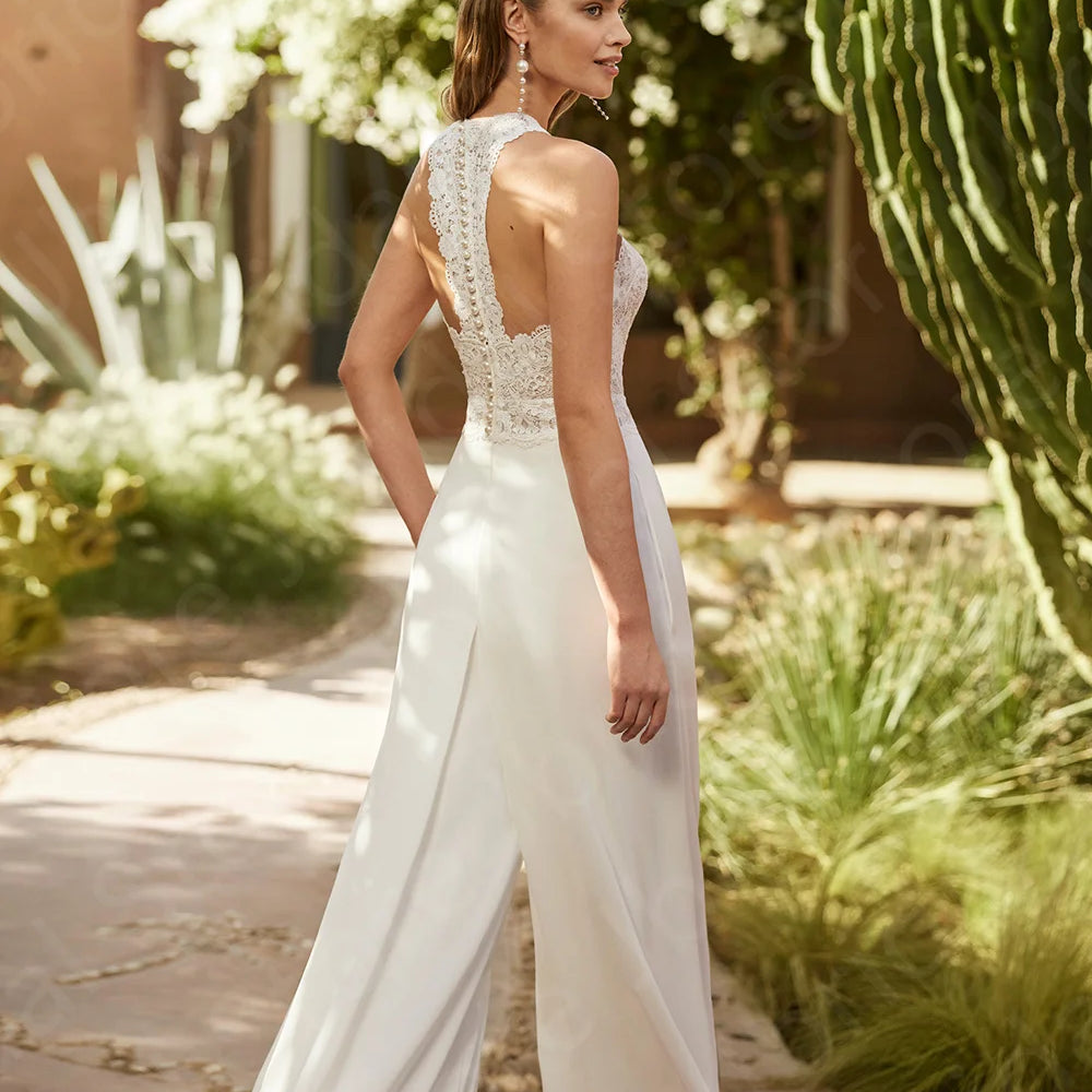 
                      
                        Woman wearing a bridal white lace halter top and wide-leg pants on a white background wedding jumpsuit
                      
                    