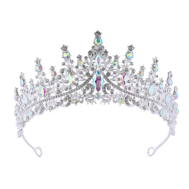 
                      
                        Silver tiara with colorful gemstones on a white background
                      
                    
