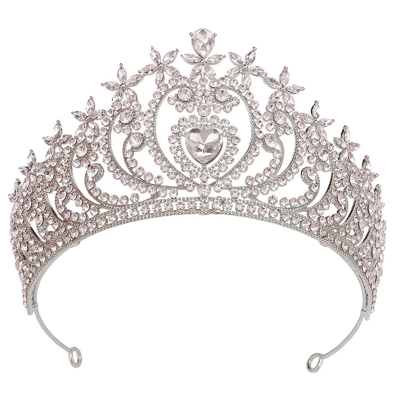 
                      
                        Silver tiara with intricate design and heart-shaped center on a white background
                      
                    