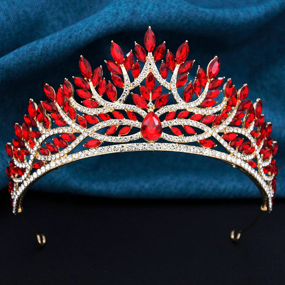 Red gemstone tiara on a dark blue fabric background