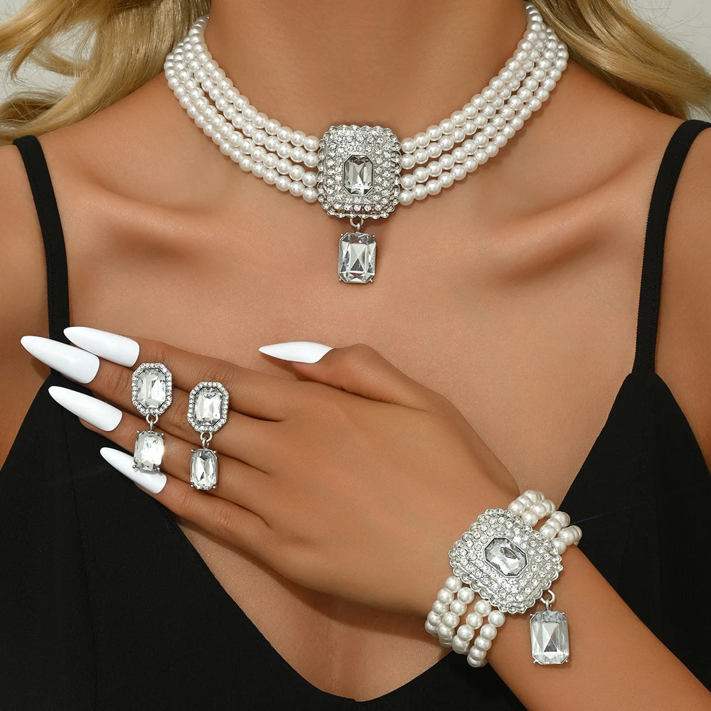 
                      
                        Pearl necklace, earrings, and bracelet set on a model with black stones
                      
                    