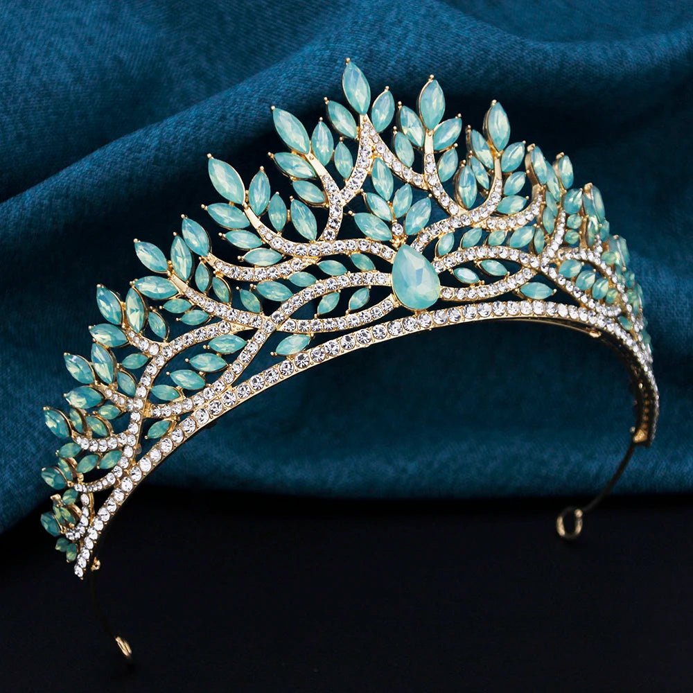 Ornate tiara with turquoise stones on a dark blue fabric background