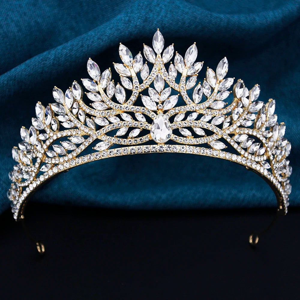 
                      
                        Elegant tiara with crystals on a dark blue fabric background
                      
                    