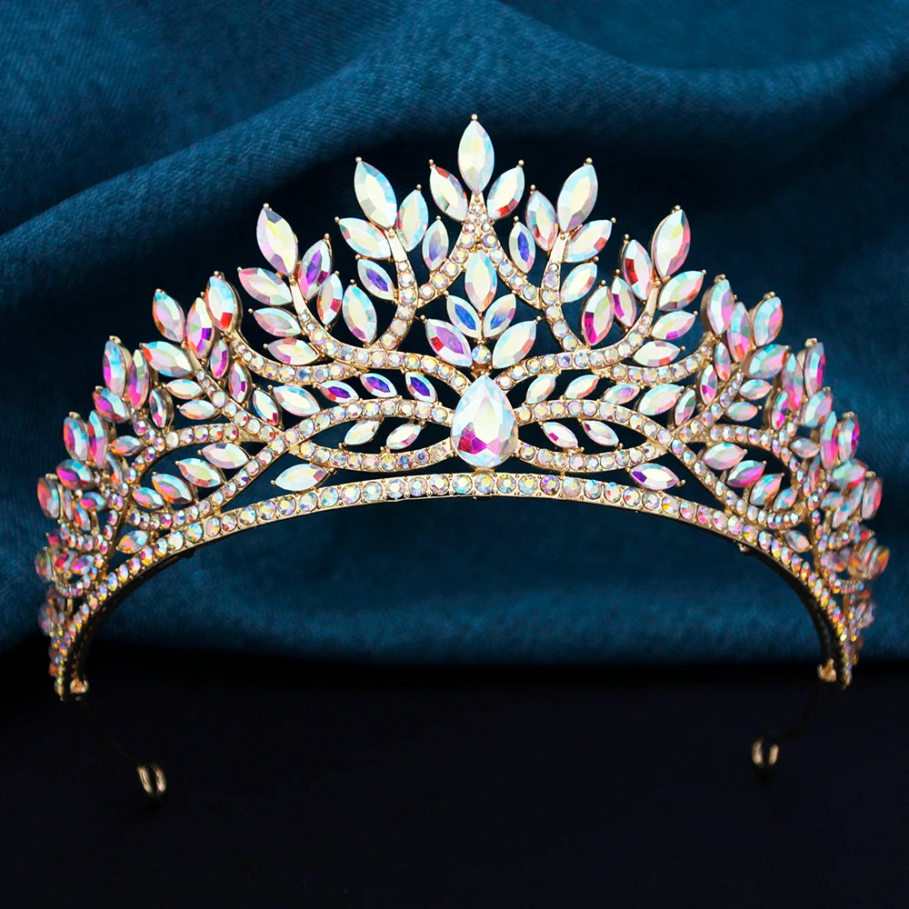 
                      
                        Elegant tiara with multicolored gemstones on a dark blue fabric background
                      
                    