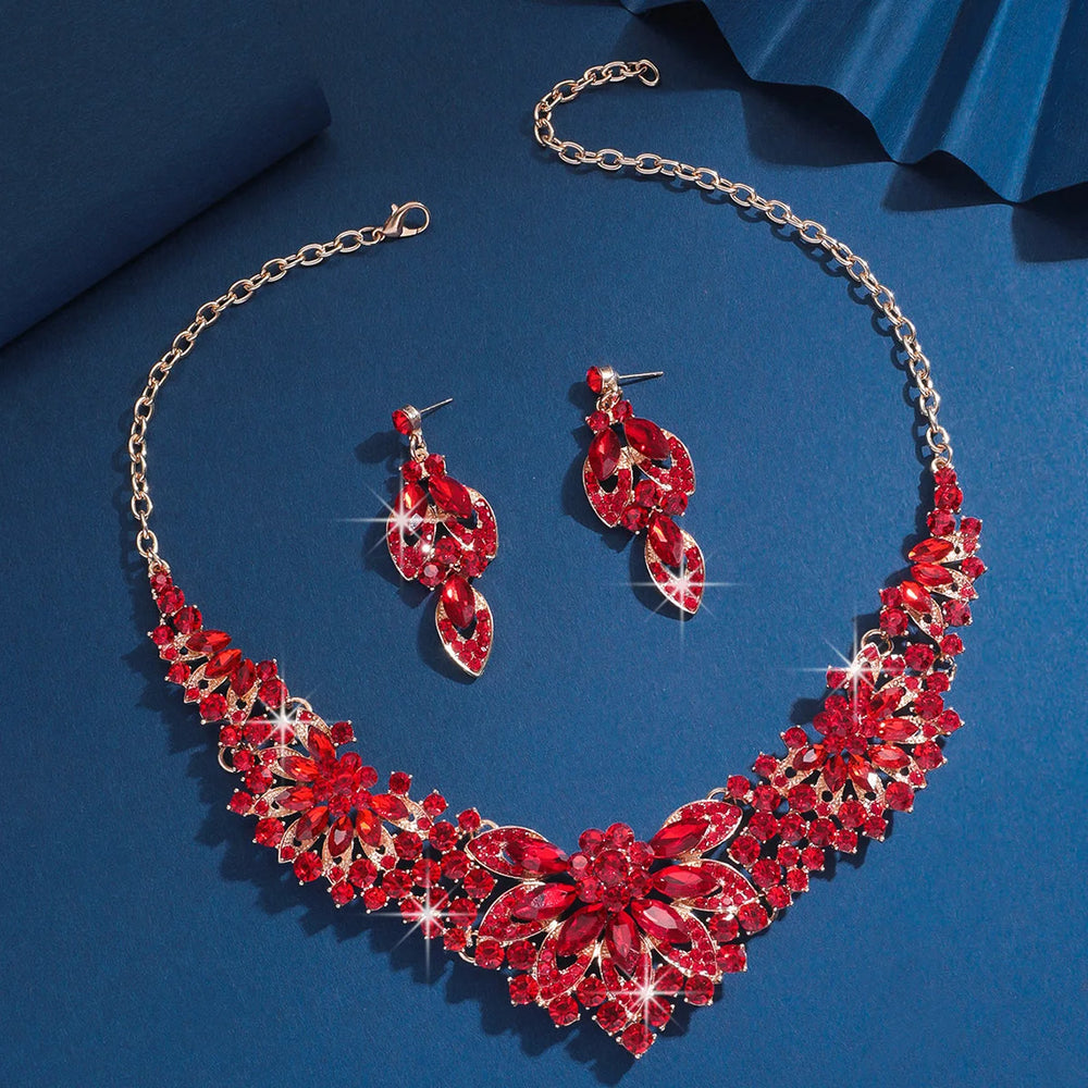 Red jewelry set with necklace and earrings on a blue background