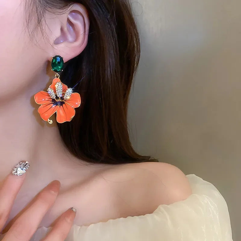 Close-up of a person wearing a floral earring with a blurred background