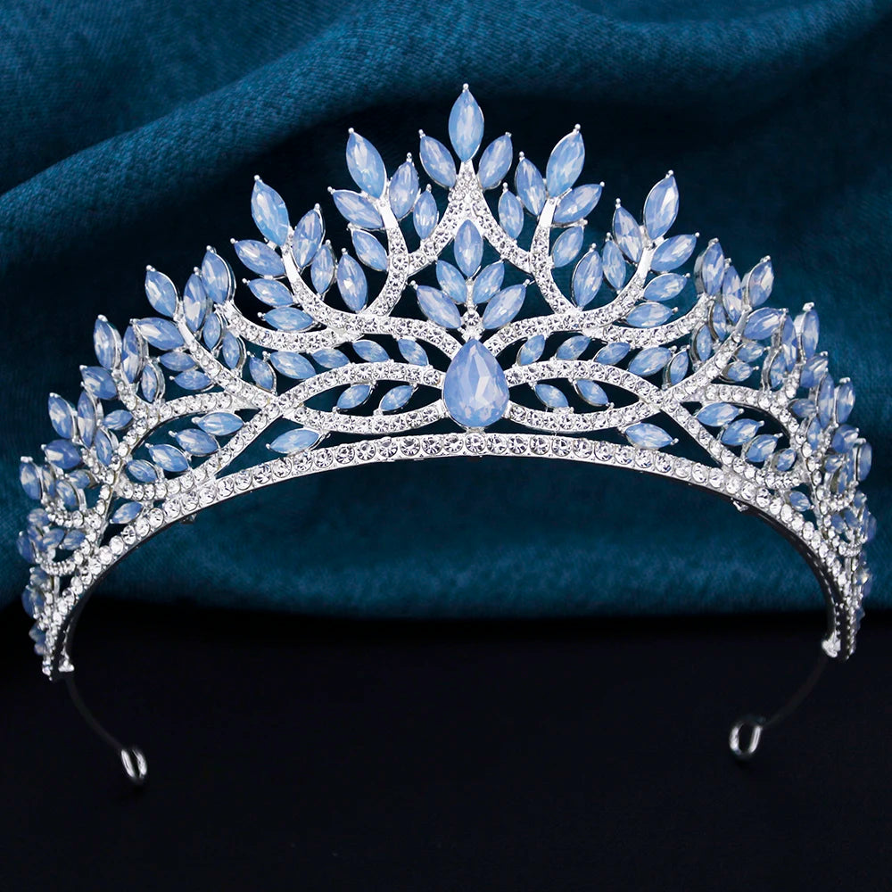 
                      
                        Elegant tiara with blue stones on a dark background
                      
                    