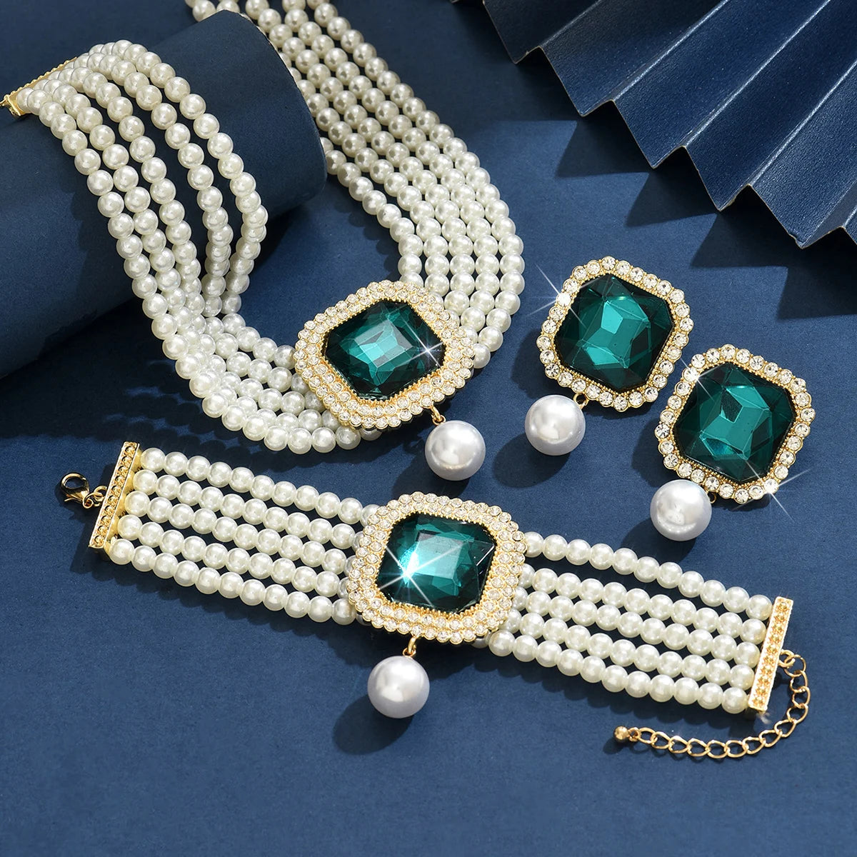 Pearl and emerald green gemstone jewelry set on a model