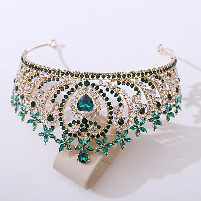
                      
                        Ornate gold and green gemstone necklace on a white background
                      
                    