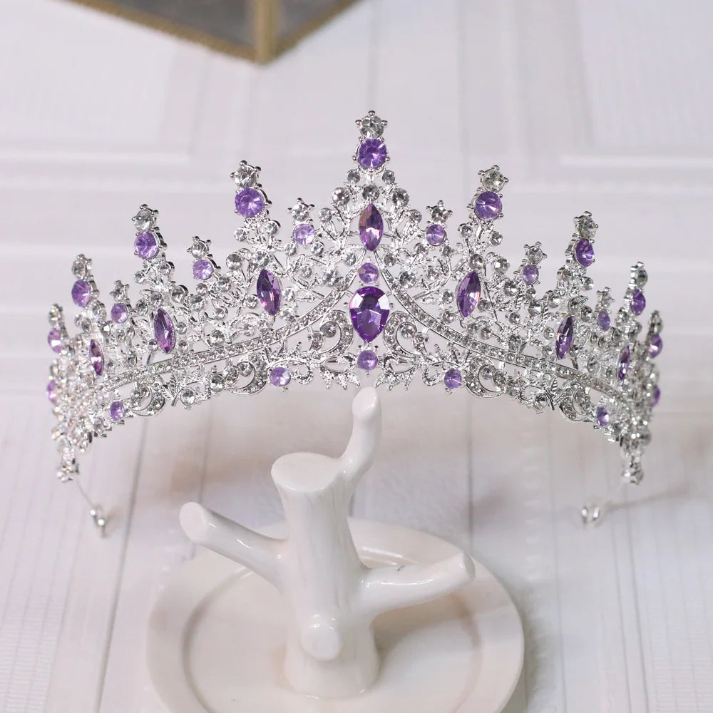 
                      
                        Purple and silver tiara on a white stand with a light background
                      
                    