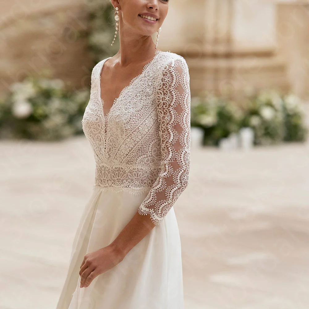 
                      
                        Woman wearing a lace wedding dress jumpsuit with a blurred outdoor background
                      
                    