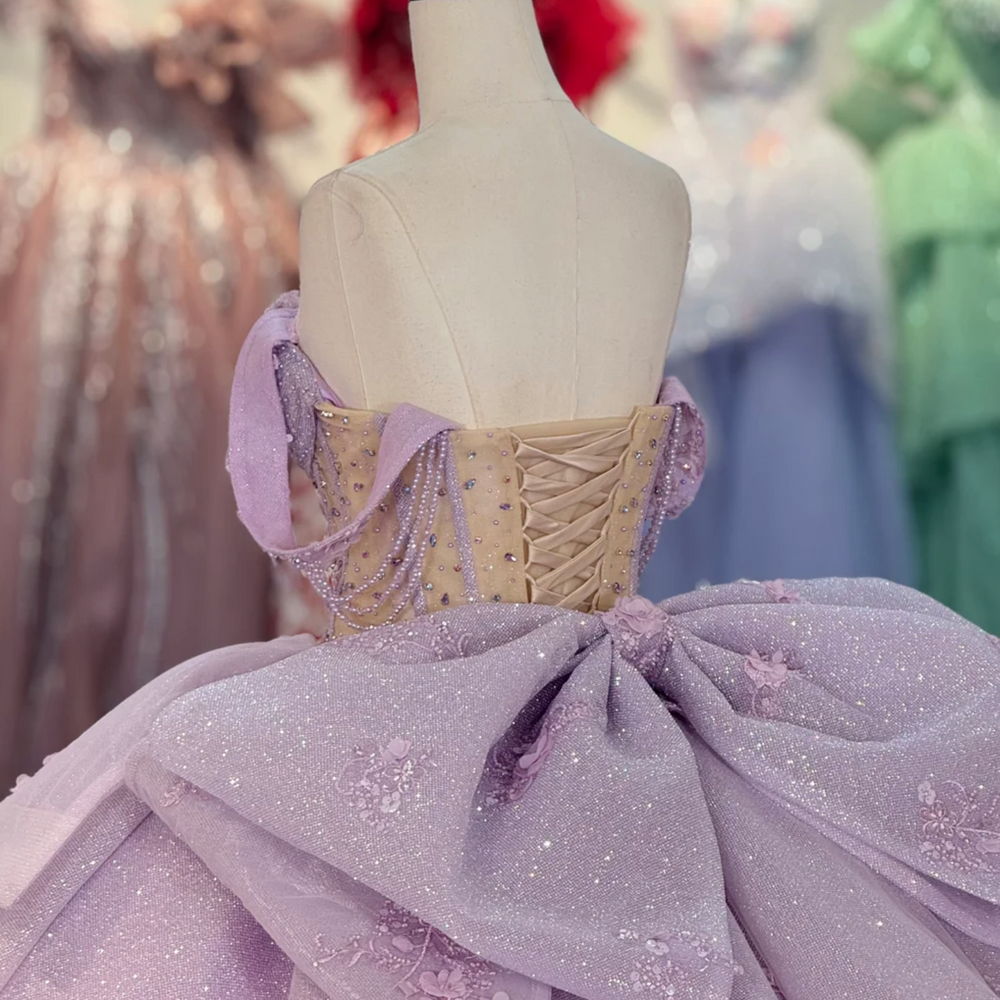 
                      
                        Elegant purple gown on a mannequin in a room 
                      
                    