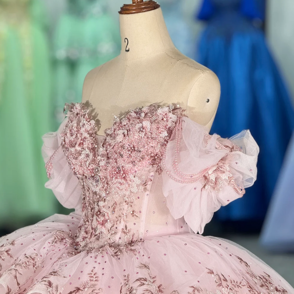 
                      
                        pink quinceanera ball gown in a reception hall
                      
                    