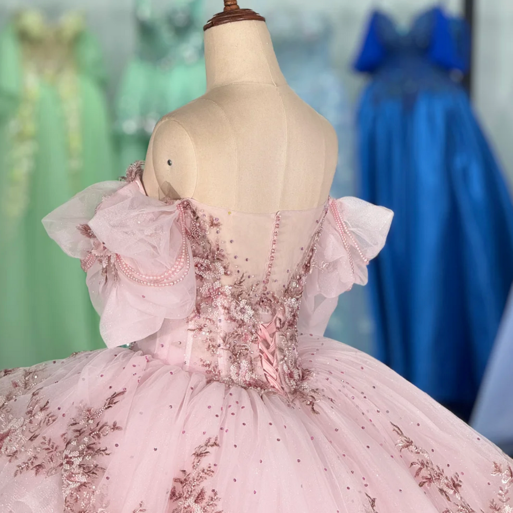 
                      
                        pink quinceanera ball gown in a reception hall
                      
                    