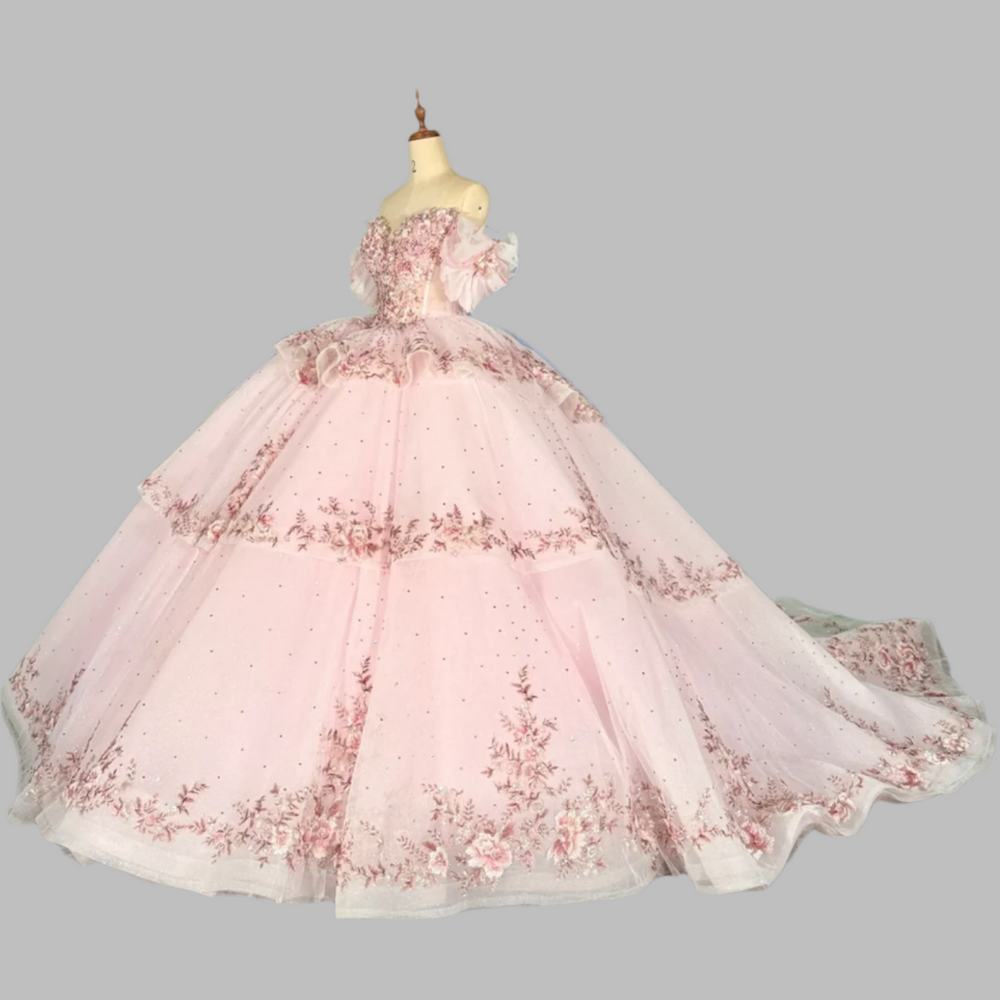 
                      
                        pink quinceanera ball gown in a reception hall
                      
                    