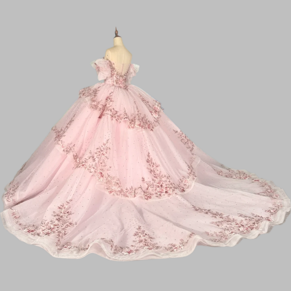 
                      
                        pink quinceanera ball gown in a reception hall
                      
                    