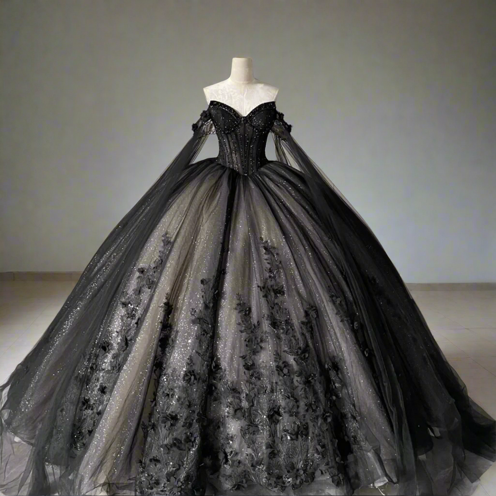Black evening gown on a mannequin against a gray tiled wall