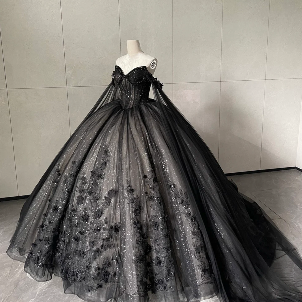 
                      
                        Black evening gown on a mannequin against a gray tiled wall
                      
                    