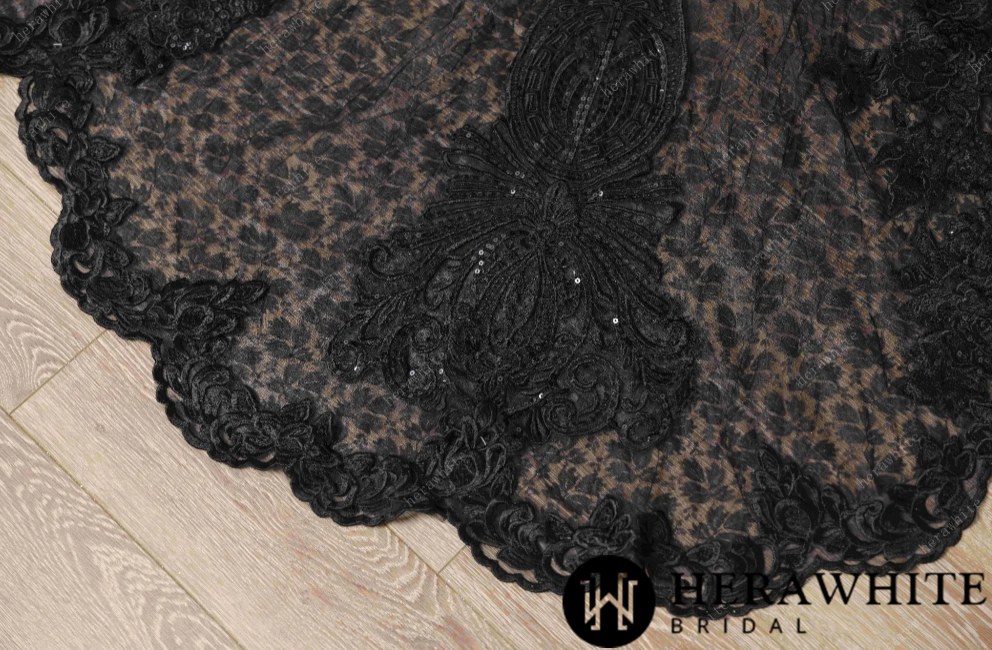 
                      
                        Black lace evening gown on a mannequin against a neutral background


                      
                    
