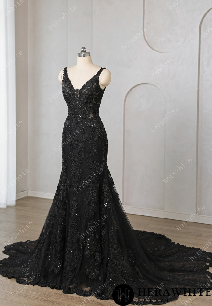 
                      
                        Black lace evening gown on a mannequin against a neutral background


                      
                    