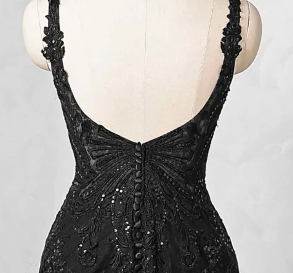 
                      
                        Black lace evening gown on a mannequin against a neutral background


                      
                    