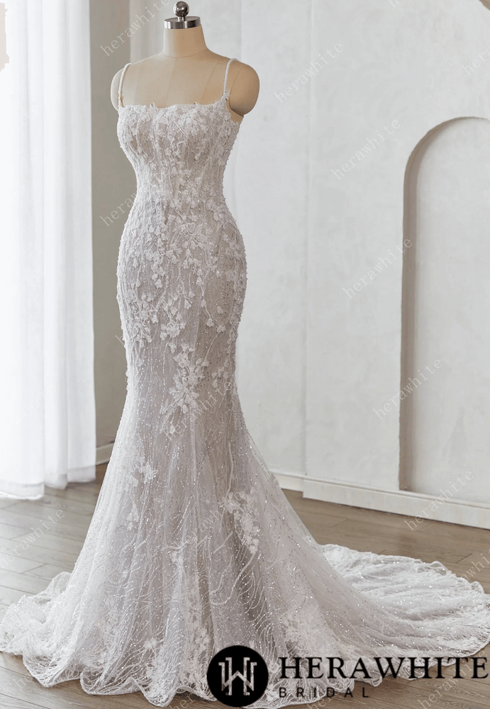 
                      
                        White lace wedding dress on a mannequin against a white background 
                      
                    