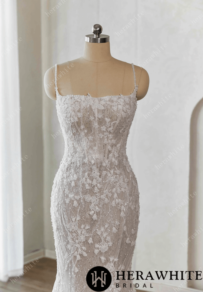 
                      
                        White lace wedding dress on a mannequin against a white background 
                      
                    