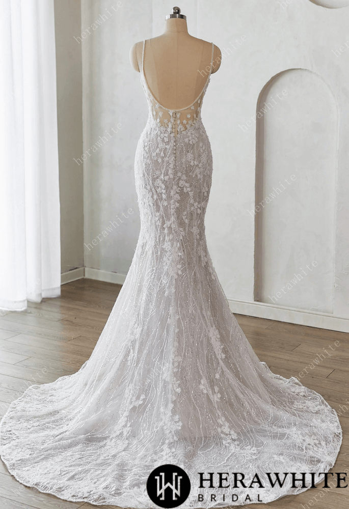
                      
                        White lace wedding dress on a mannequin against a white background 
                      
                    
