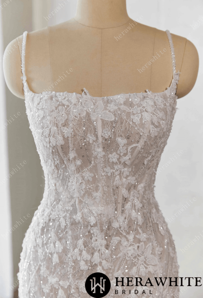 
                      
                        White lace wedding dress on a mannequin against a white background 
                      
                    