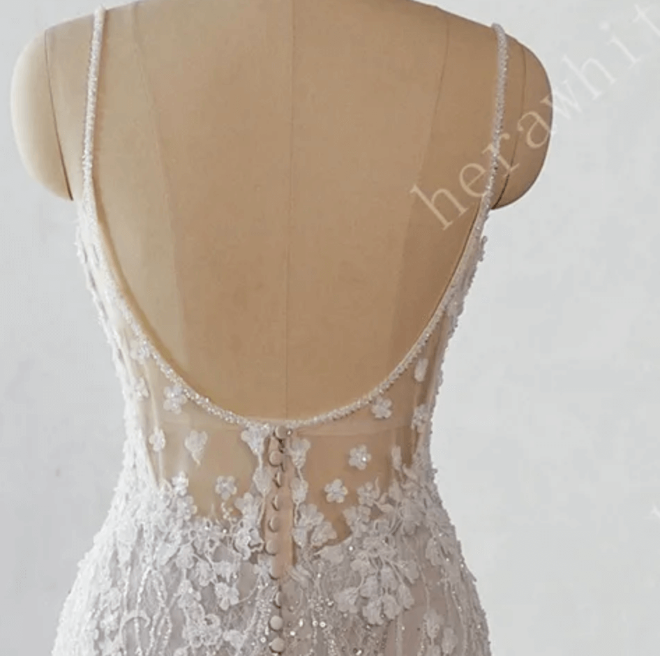 
                      
                        White lace wedding dress on a mannequin against a white background 
                      
                    