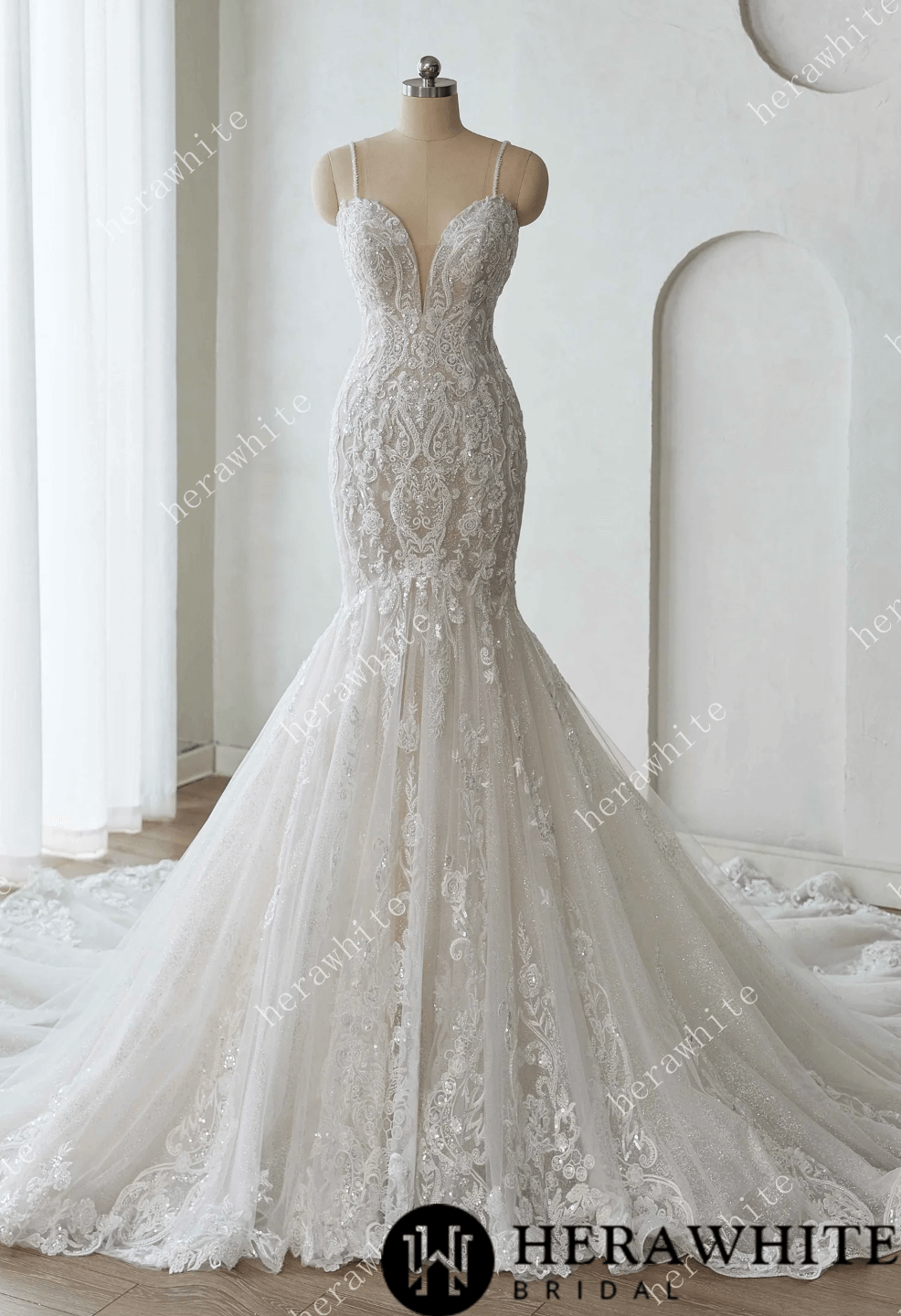 Elegant lace wedding dress on a mannequin against a white background with 'Herawhite Bridal' branding.