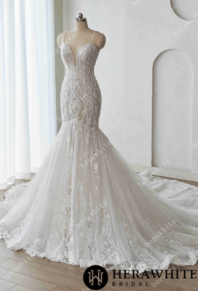 
                      
                        Elegant lace wedding dress on a mannequin against a white background with 'Herawhite Bridal' branding.
                      
                    