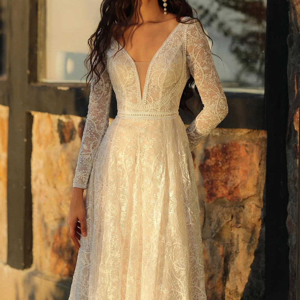 
                      
                        Boho A-Line long sleeve wedding dress with deep V-neckline and lace detailing, perfect for a romantic bridal look.
                      
                    