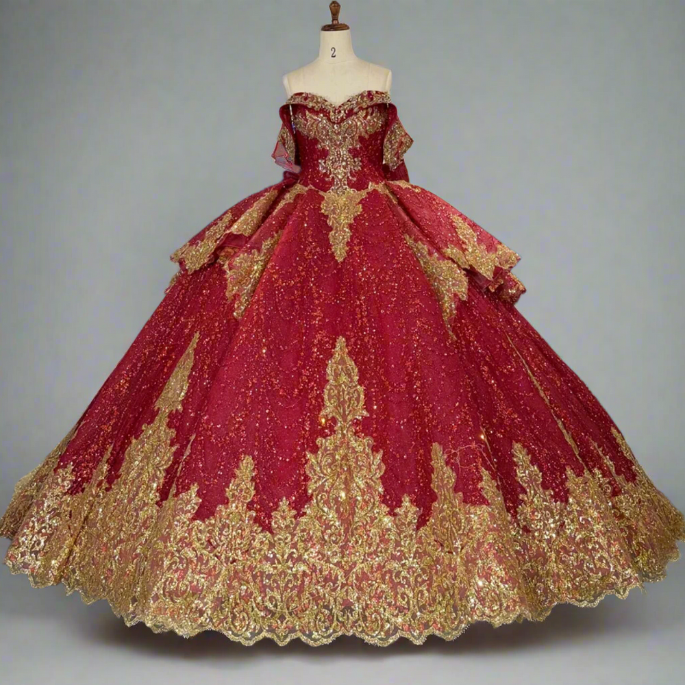 Red and gold ball gown on a mannequin in a store with other dresses in the background.