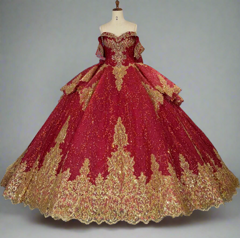 Red and gold ball gown on a mannequin in a store with other dresses in the background.